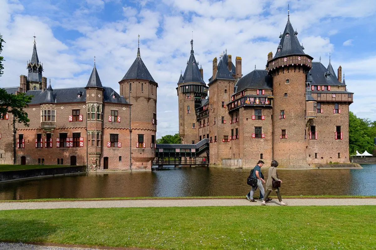 De Haar Castle with its towers reflected in the moat on a sunny day
