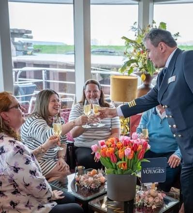 The captain toasting guests with champagne at the welcome reception on board the AmaSiena