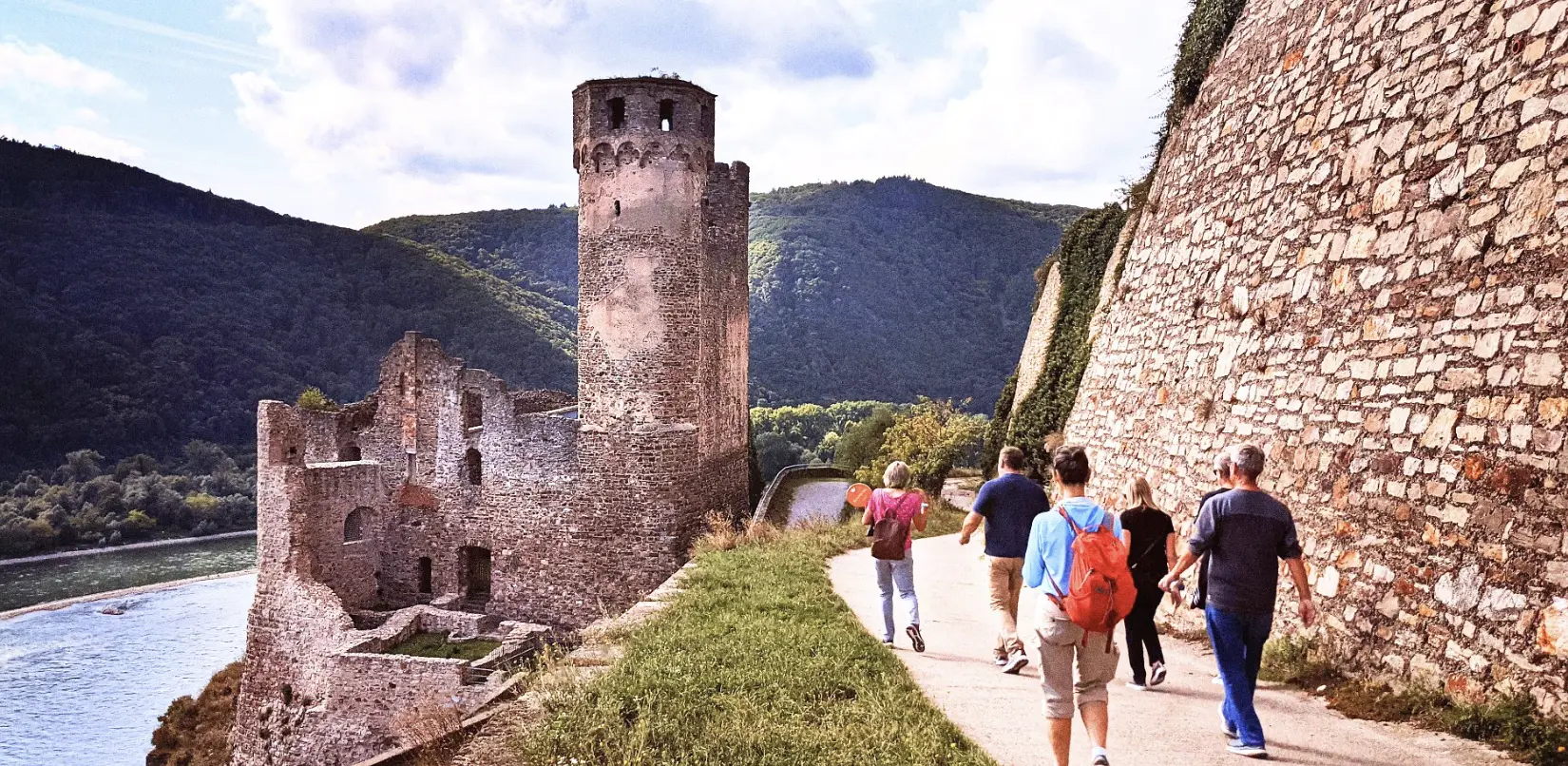 Travelers walking through a Rhine castle above the river