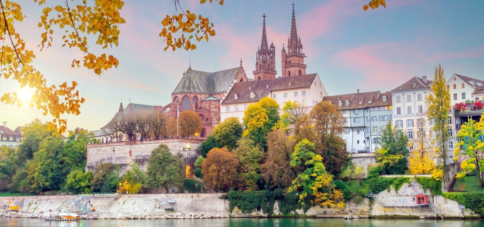 Basel old town and the red sandstone Munster towers along the Rhine in autumn